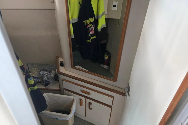 Slide: The Image of 1994 Sea Ray 370 Sedan Bridge interior with white leather seating and window view. - 13