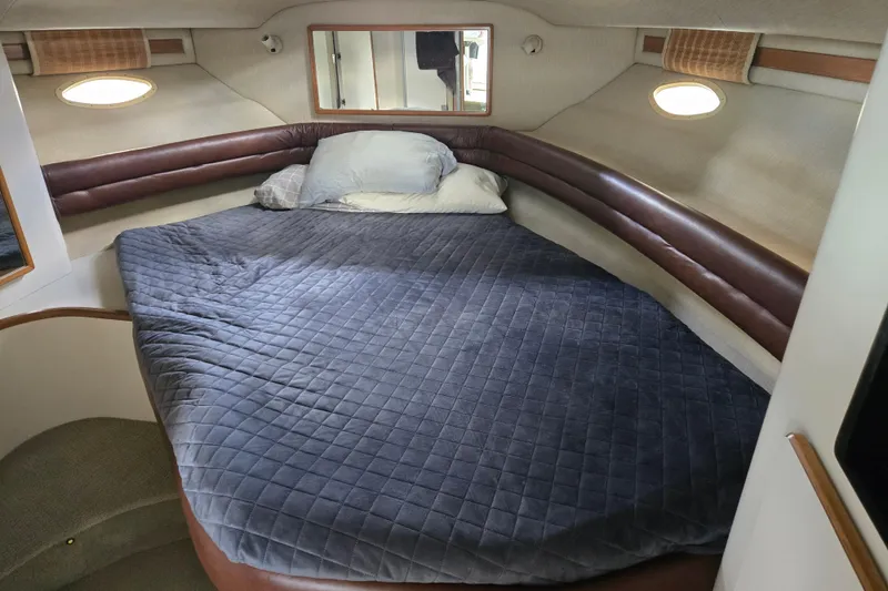 Slide: The Image of Interior of 1994 Sea Ray 370 Sedan Bridge with curved seating and TV. - 14