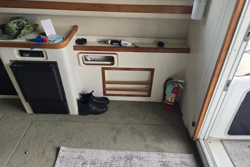 Slide: The Image of Compact kitchen area in a 1994 Sea Ray 370 Sedan Bridge yacht, featuring stove and storage. - 17