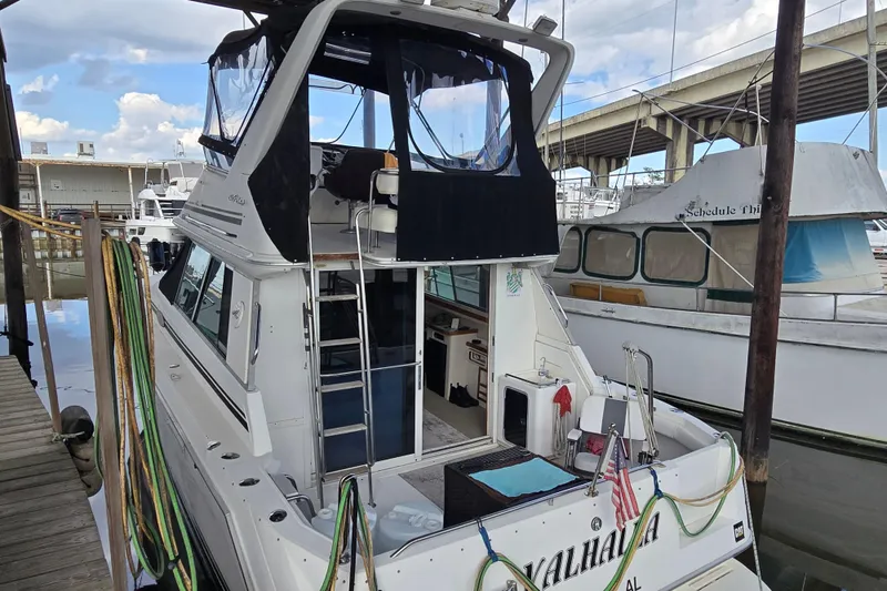 Slide: The Image of 1994 Sea Ray 370 Sedan Bridge yacht docked, front view, with sleek design and modern features. - 2