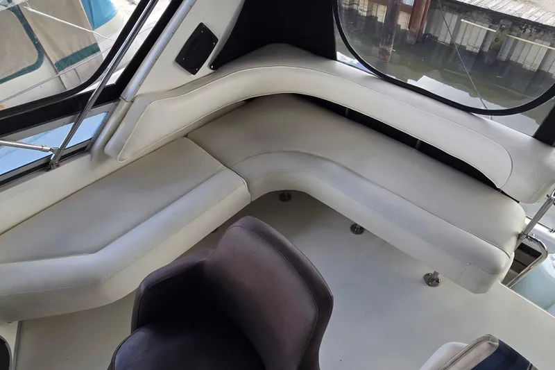Slide: The Image of Interior of 1994 Sea Ray 370 Sedan Bridge with U-Line fridge and black shoes. - 23