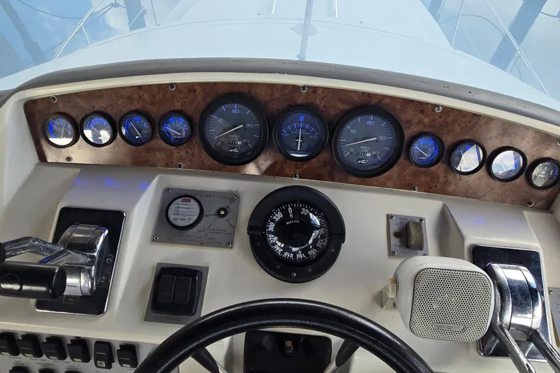 Slide: The Image of 1994 Sea Ray 370 Sedan Bridge deck with chairs, storage, and water reflections. - 24