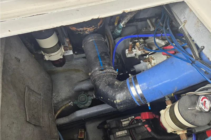 Slide: The Image of Engine compartment of a 1994 Sea Ray 370 Sedan Bridge with visible hoses and components. - 7