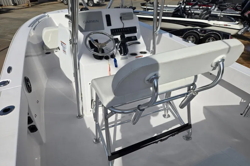 Slide: The Image of 2024 Aquasport 2200 Center Console boat interior with steering wheel and seating. - 12