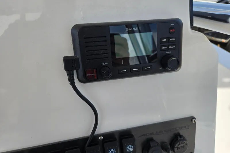 Slide: The Image of Garmin marine radio on 2024 Aquasport 2200 Center Console dashboard. - 15