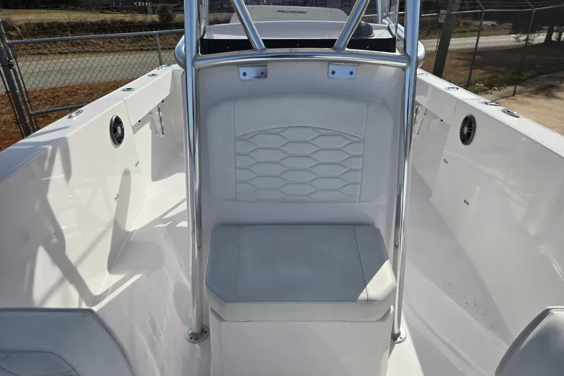 Slide: The Image of 2024 Aquasport 2200 Center Console boat interior with white seating and stainless steel railings. - 16