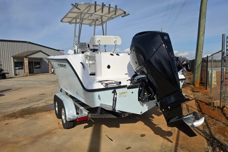 Slide: The Image of 2024 Aquasport 2200 Center Console boat on trailer, featuring powerful outboard motor. - 24