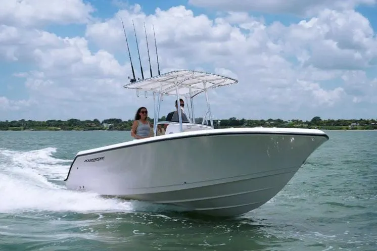 Slide: The Image of Manufacturer Provided Image: 2024 Aquasport 2200 Center Console boat cruising on a sunny day. - 27