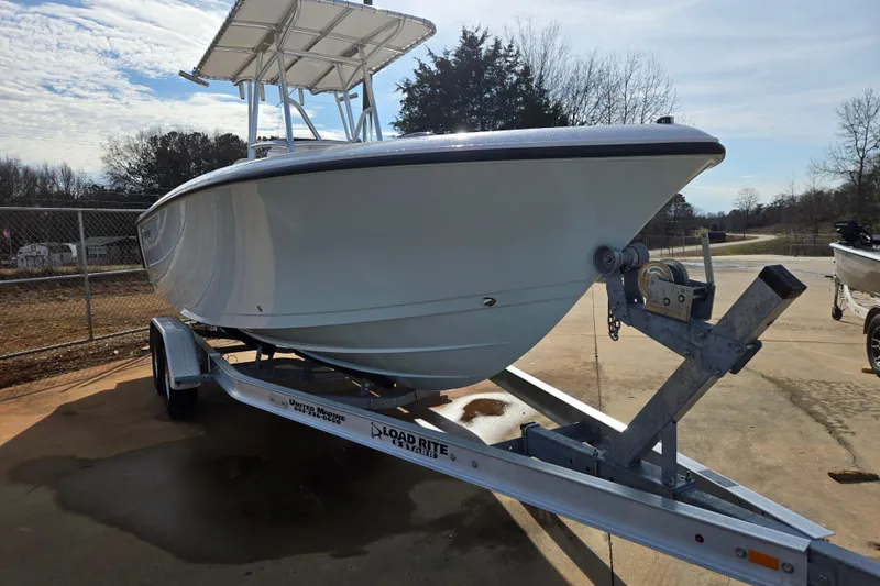 Slide: The Image of 2024 Aquasport 2200 Center Console boat on trailer, parked outdoors. - 5