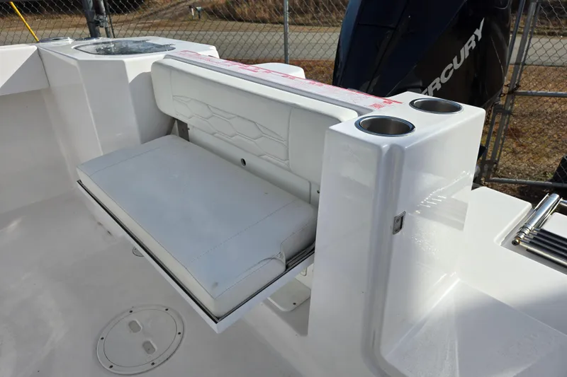 Slide: The Image of 2024 Aquasport 2200 Center Console boat with foldable seating and cup holders. - 6