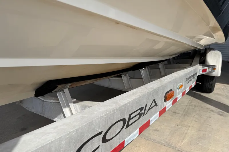 Slide: The Image of 2015 Cobia 344 Center Console boat on a trailer, side view. - 10
