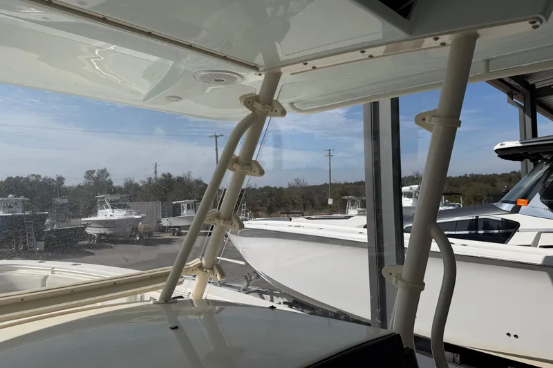 Slide: The Image of 2015 Cobia 344 Center Console boat interior with marina view. - 100