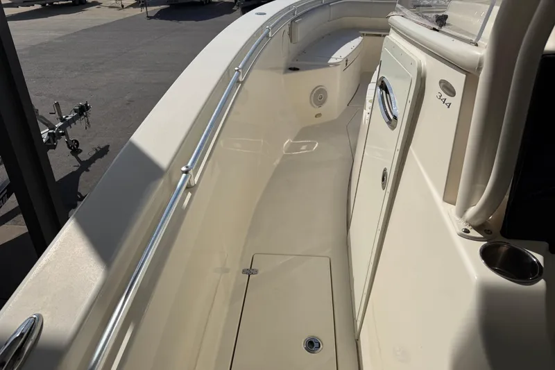 Slide: The Image of 2015 Cobia 344 Center Console boat deck with sleek design and stainless steel railings. - 103