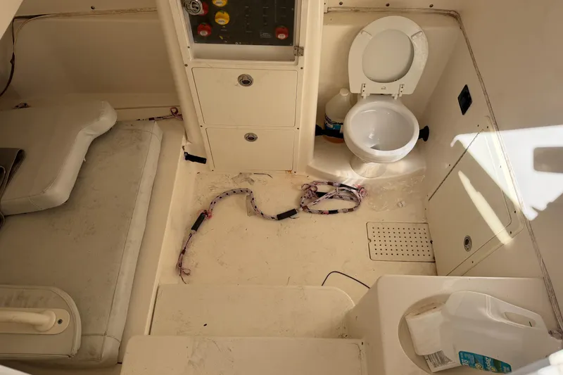 Slide: The Image of 2015 Cobia 344 Center Console interior with toilet and storage compartments. - 104