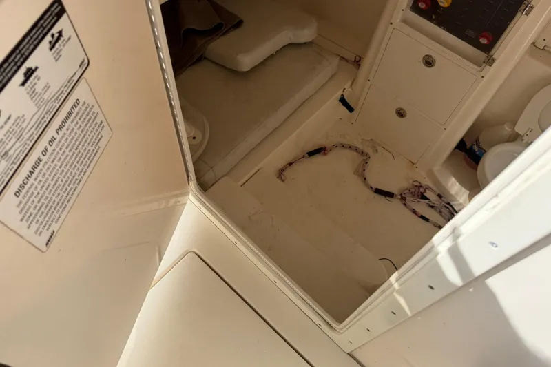 Slide: The Image of 2015 Cobia 344 Center Console interior with storage and wiring. - 105