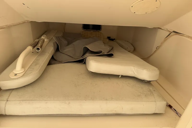 Slide: The Image of Interior storage area of a 2015 Cobia 344 Center Console boat with cushions. - 106
