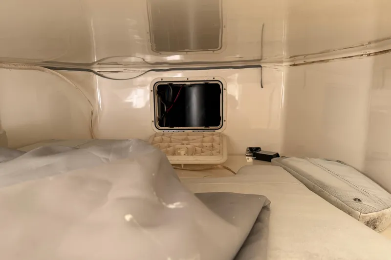 Slide: The Image of Interior cabin of 2015 Cobia 344 Center Console boat, featuring storage and seating area. - 107