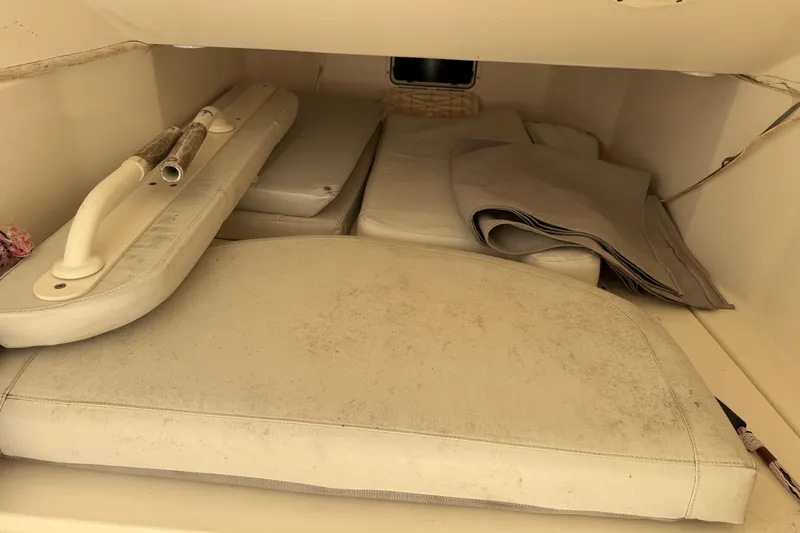 Slide: The Image of Storage compartment of a 2015 Cobia 344 Center Console boat with cushions and equipment. - 112