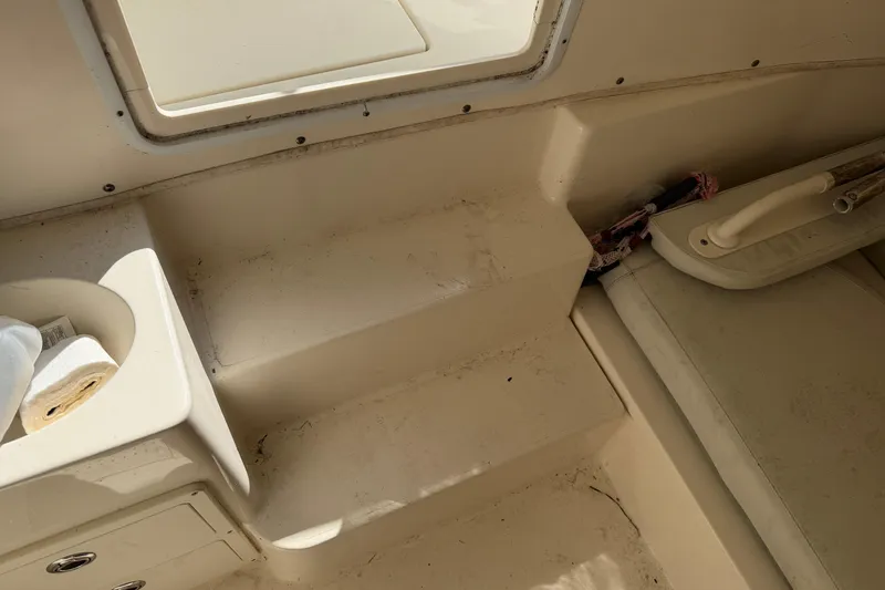 Slide: The Image of Interior of 2015 Cobia 344 Center Console boat, featuring seating and storage area. - 113