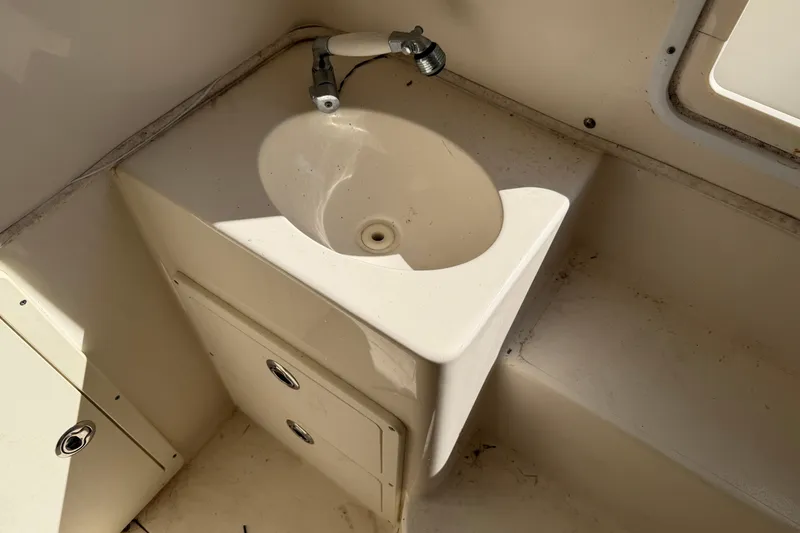 Slide: The Image of 2015 Cobia 344 Center Console boat sink and storage area. - 114