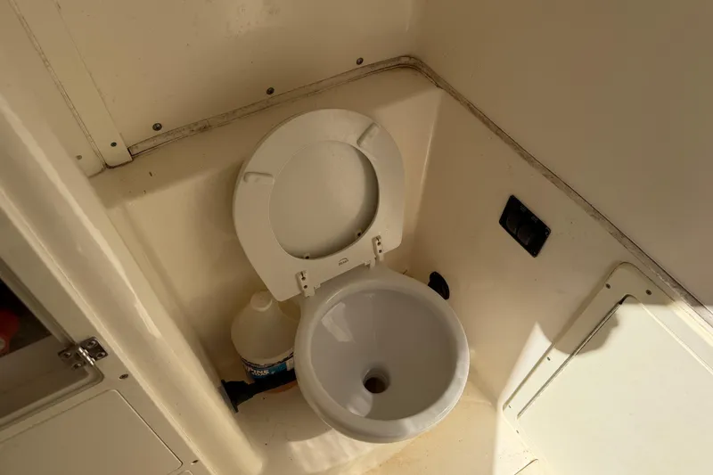Slide: The Image of 2015 Cobia 344 Center Console boat toilet interior view. - 115