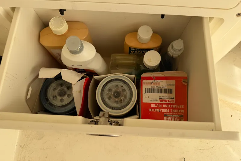 Slide: The Image of Drawer with marine supplies, including Yamaha fuel filter, on a 2015 Cobia 344 Center Console. - 117