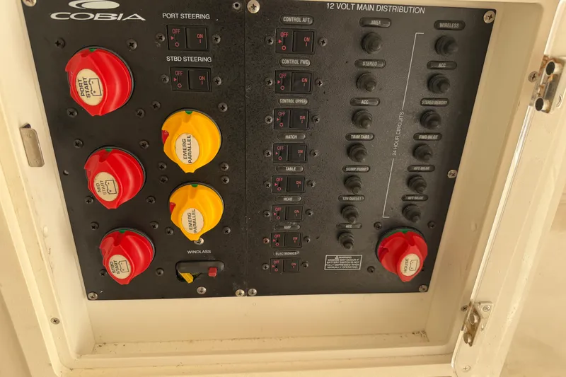 Slide: The Image of Control panel of a 2015 Cobia 344 Center Console boat with switches and dials. - 119