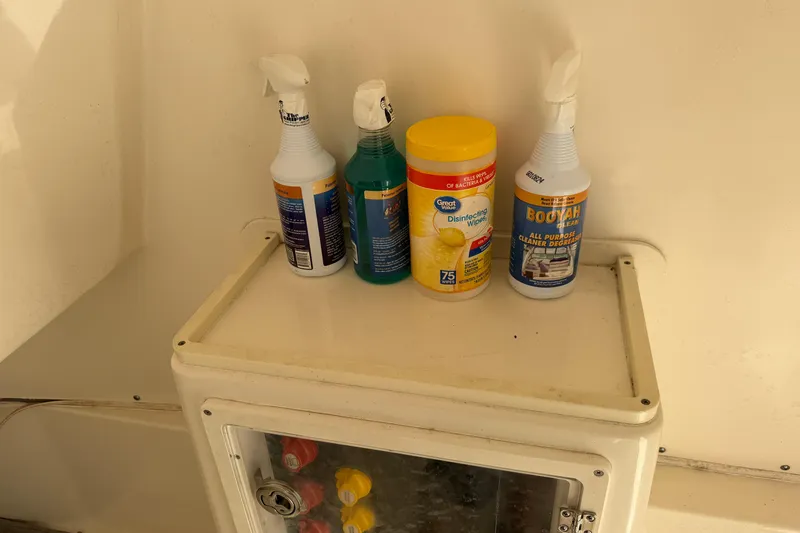 Slide: The Image of Cleaning supplies on a 2015 Cobia 344 Center Console boat shelf. - 120