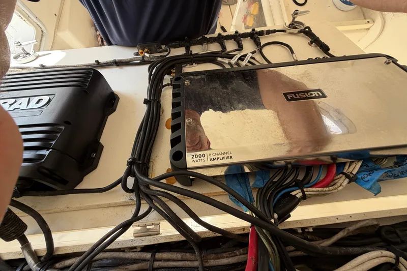 Slide: The Image of 2015 Cobia 344 Center Console with Fusion amplifier and wiring setup. - 133