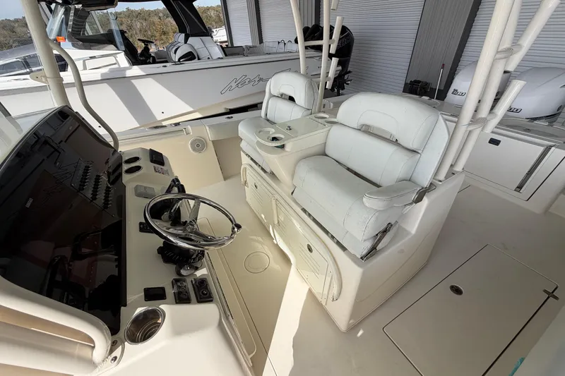 Slide: The Image of 2015 Cobia 344 Center Console boat interior with steering wheel and seating. - 135