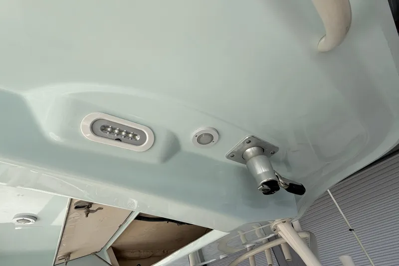 Slide: The Image of 2015 Cobia 344 Center Console boat underside with mounted light and hardware. - 136