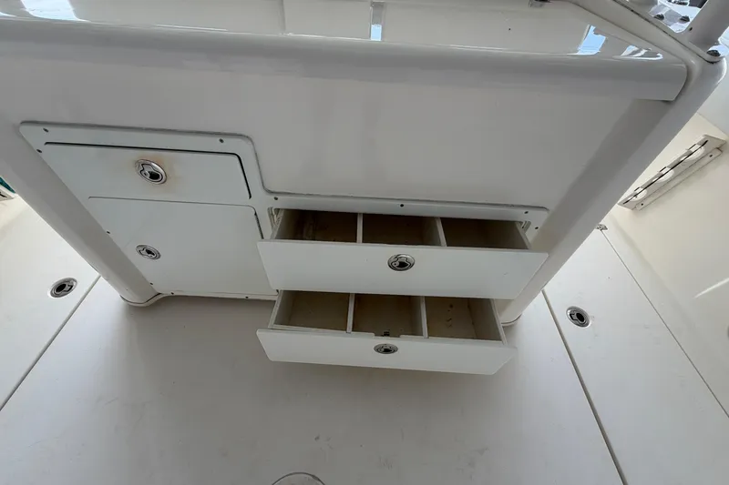 Slide: The Image of 2015 Cobia 344 Center Console storage drawers and compartments on deck. - 137