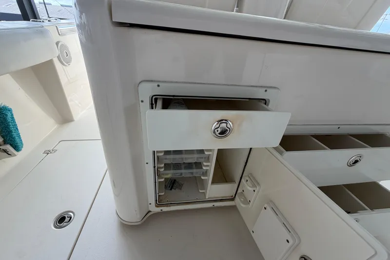 Slide: The Image of 2015 Cobia 344 Center Console boat interior storage compartment with open drawer. - 138