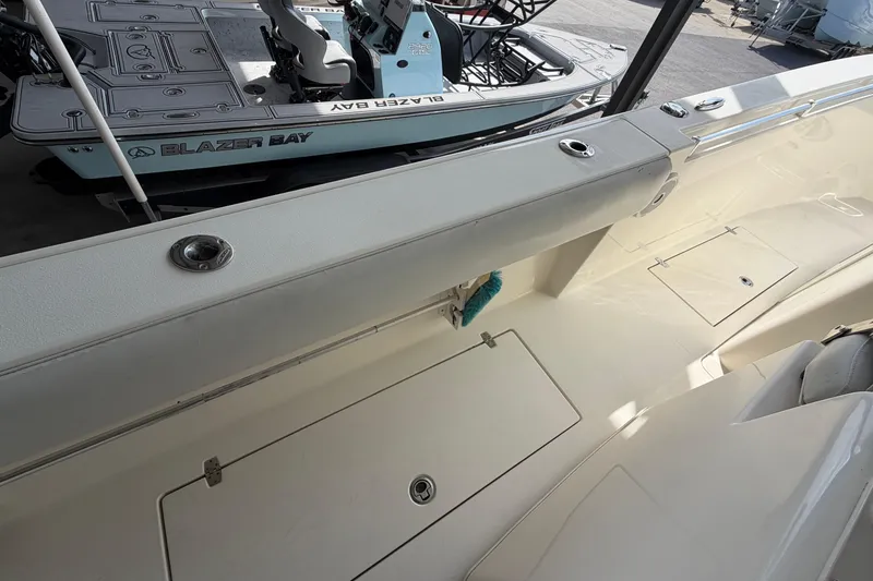 Slide: The Image of 2015 Cobia 344 Center Console boat interior with storage compartments and seating. - 140