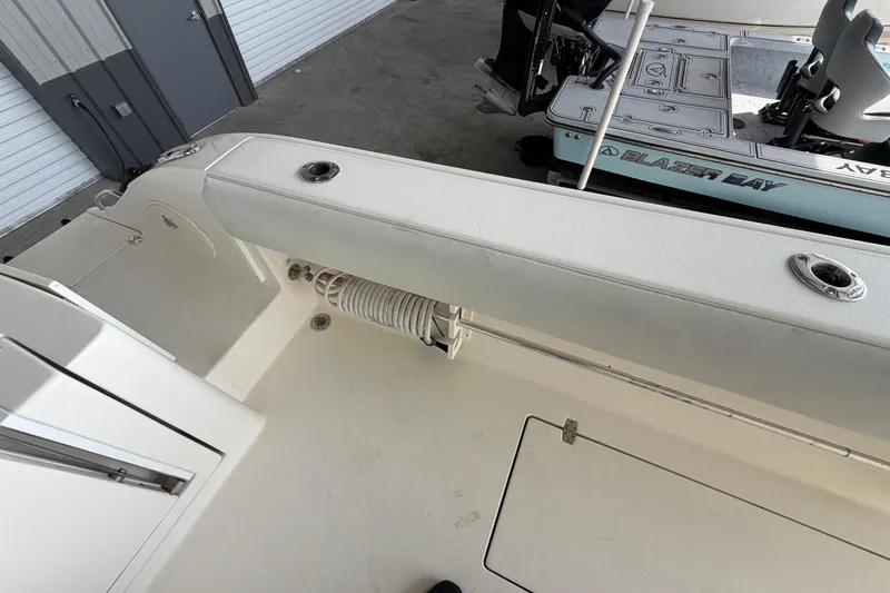 Slide: The Image of 2015 Cobia 344 Center Console boat interior with storage and seating area. - 141