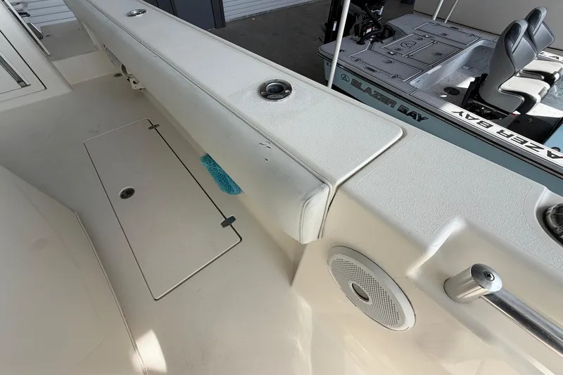 Slide: The Image of 2015 Cobia 344 Center Console boat interior with seating and storage compartments. - 142