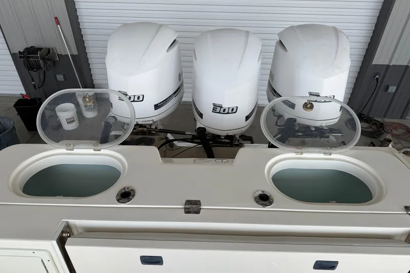 Slide: The Image of 2015 Cobia 344 Center Console with triple 300 horsepower engines, open storage compartments. - 15