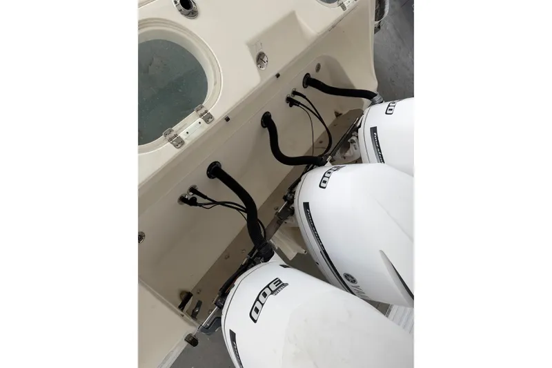 Slide: The Image of 2015 Cobia 344 Center Console with triple Yamaha outboard engines. - 150