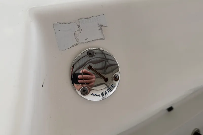 Slide: The Image of Water fill cap on 2015 Cobia 344 Center Console boat. - 152