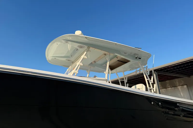 Slide: The Image of 2015 Cobia 344 Center Console boat against clear blue sky. - 159