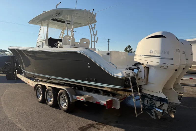 Slide: The Image of 2015 Cobia 344 Center Console boat on trailer with Yamaha engines. - 160