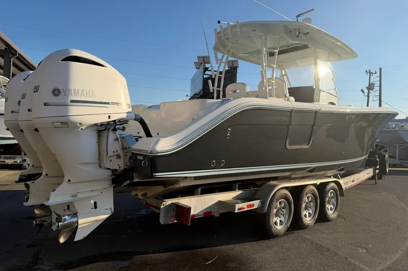 Slide: The Image of 2015 Cobia 344 Center Console boat with Yamaha engines on a trailer. - 162