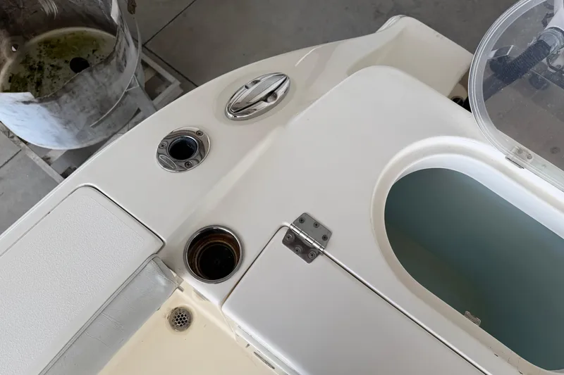 Slide: The Image of 2015 Cobia 344 Center Console boat deck with storage compartments and fittings. - 17