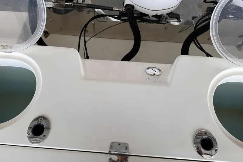 Slide: The Image of 2015 Cobia 344 Center Console boat dashboard with open compartments and visible wiring. - 18