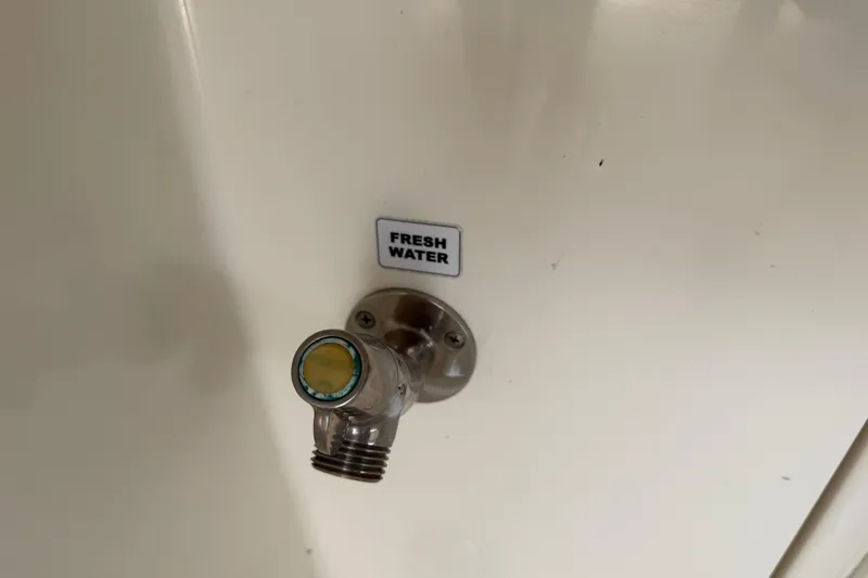 Slide: The Image of Fresh water outlet on 2015 Cobia 344 Center Console boat. - 23