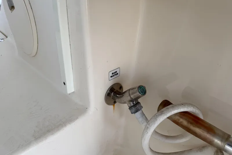 Slide: The Image of 2015 Cobia 344 Center Console raw water outlet with hose attachment. - 24