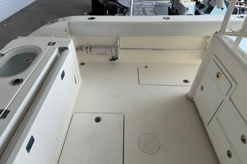 Slide: The Image of 2015 Cobia 344 Center Console boat interior with storage compartments and seating. - 32