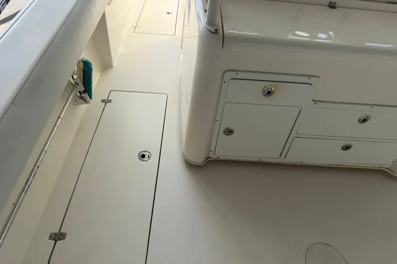 Slide: The Image of 2015 Cobia 344 Center Console boat interior with storage compartments and clean deck. - 33