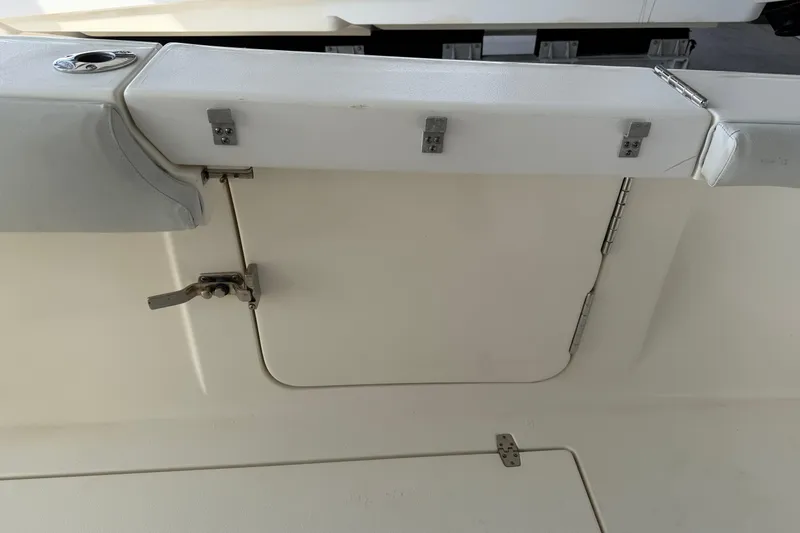Slide: The Image of 2015 Cobia 344 Center Console boat interior with storage compartment and latch. - 36