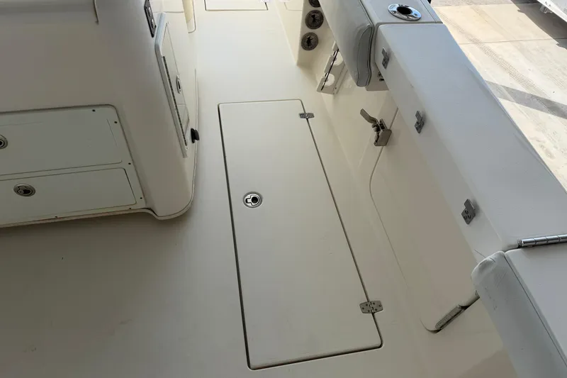Slide: The Image of 2015 Cobia 344 Center Console boat deck with storage compartments and seating. - 38
